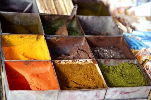 Bins of turmeric, paprika and dried herbs